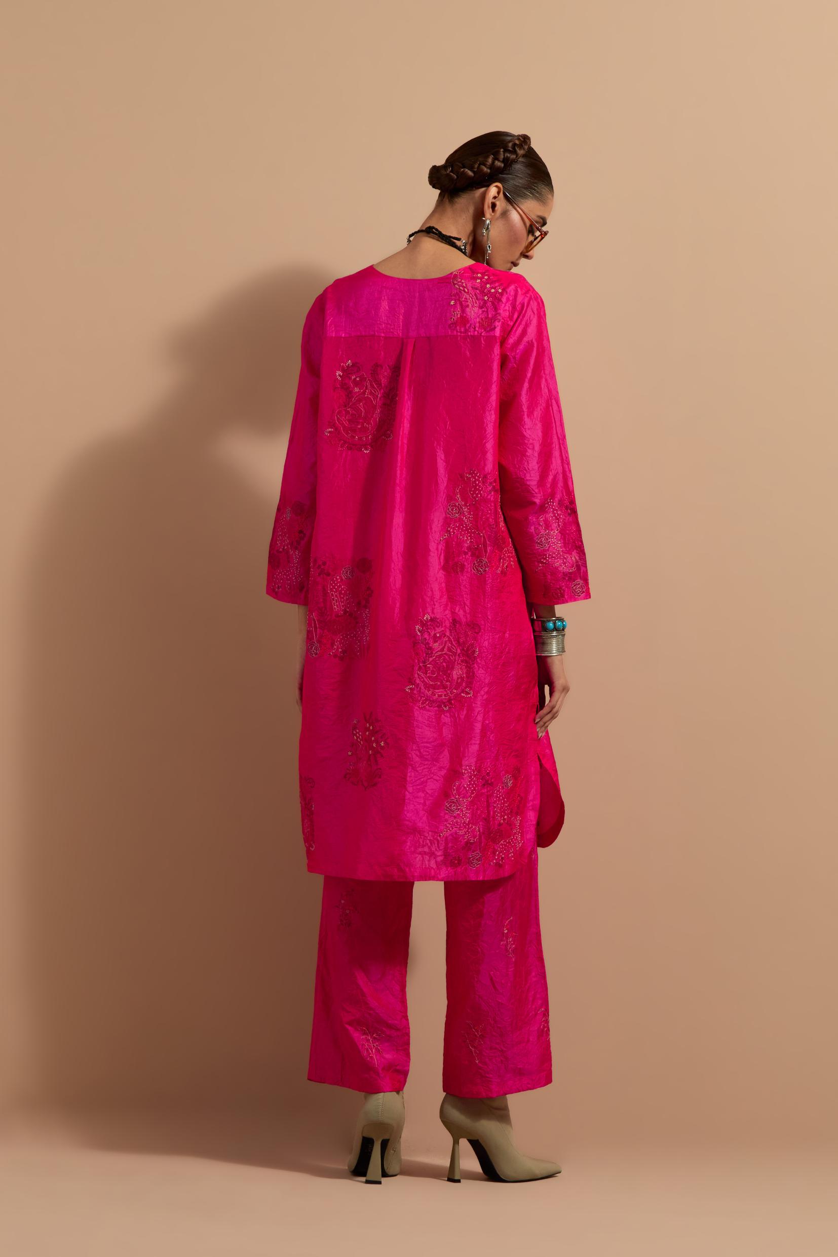 Fuchsia crushed silk short kurta set with hand block print, highlighted with multi colored thread embroidery.