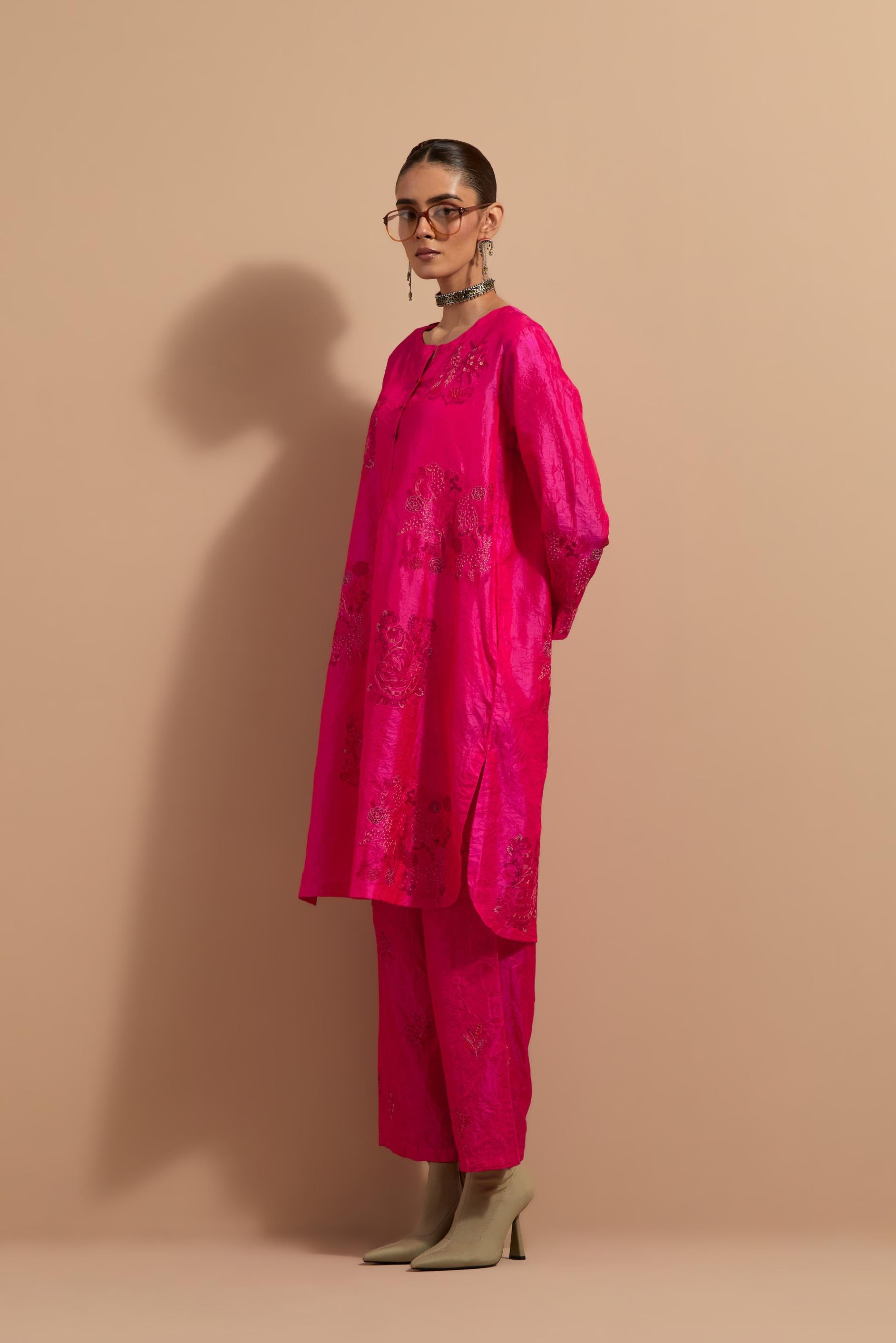 Fuchsia crushed silk short kurta set with hand block print, highlighted with multi colored thread embroidery.