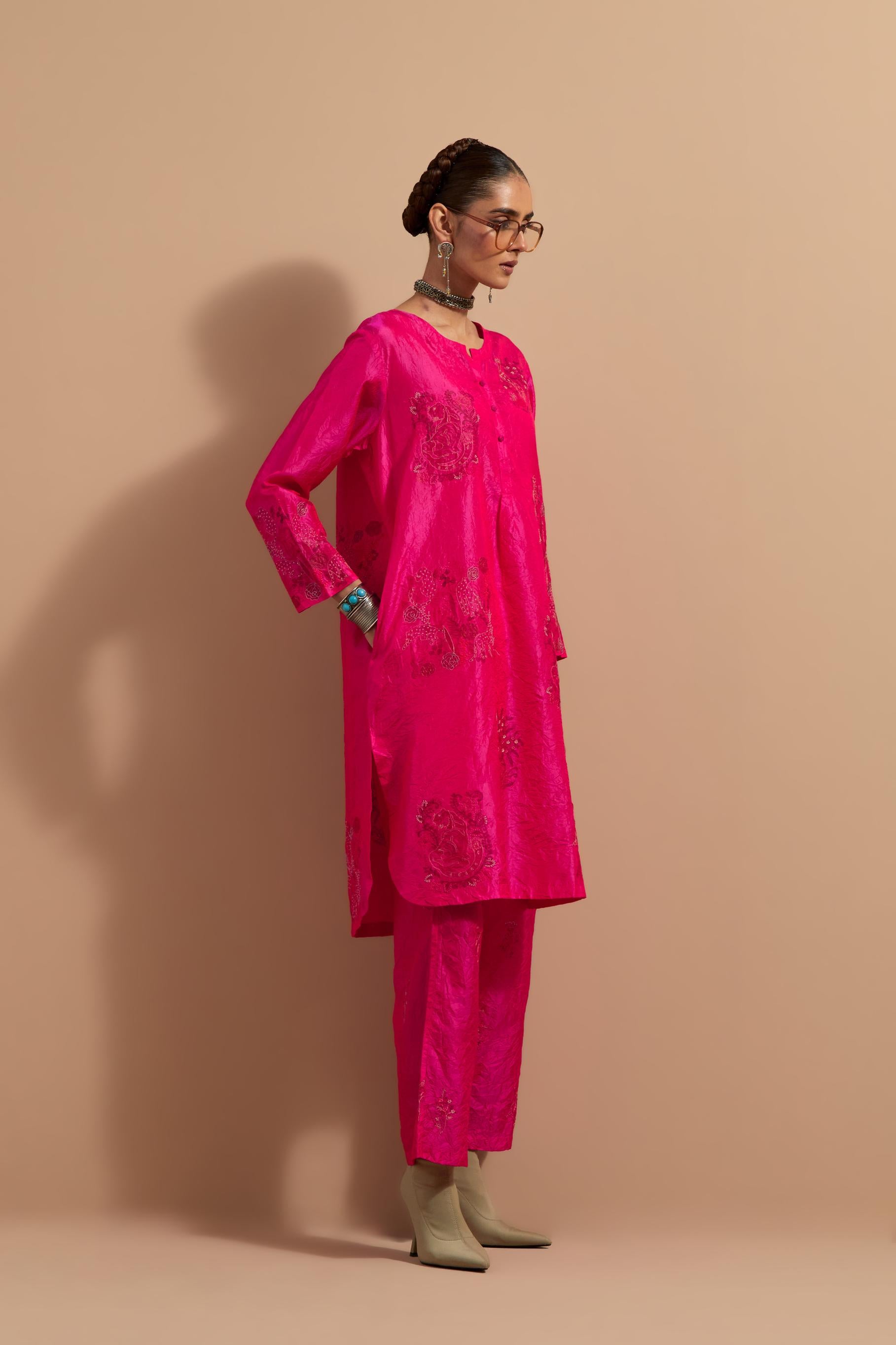 Fuchsia crushed silk short kurta set with hand block print, highlighted with multi colored thread embroidery.