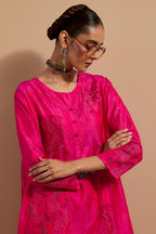 Fuchsia crushed silk short kurta set with hand block print, highlighted with multi colored thread embroidery.