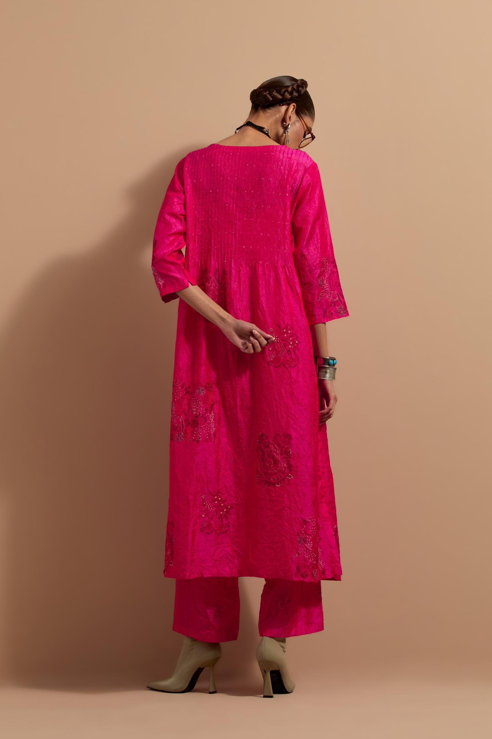 Fuchsia crushed silk hand block printed kurta set with pin tucks at yoke, highlighted with multi colored thread embroidery.