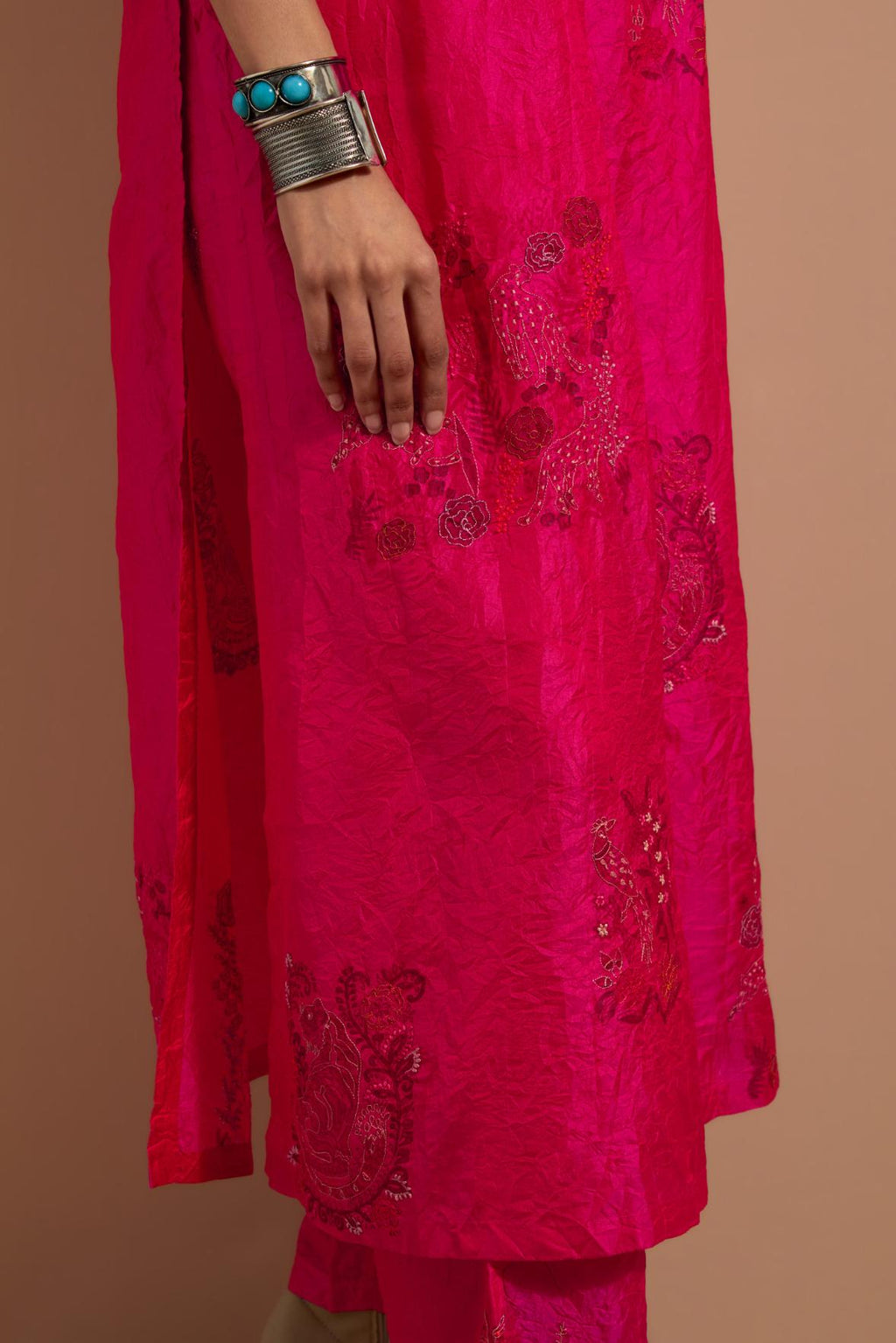 Fuchsia crushed silk hand block printed kurta set with pin tucks at yoke, highlighted with multi colored thread embroidery.