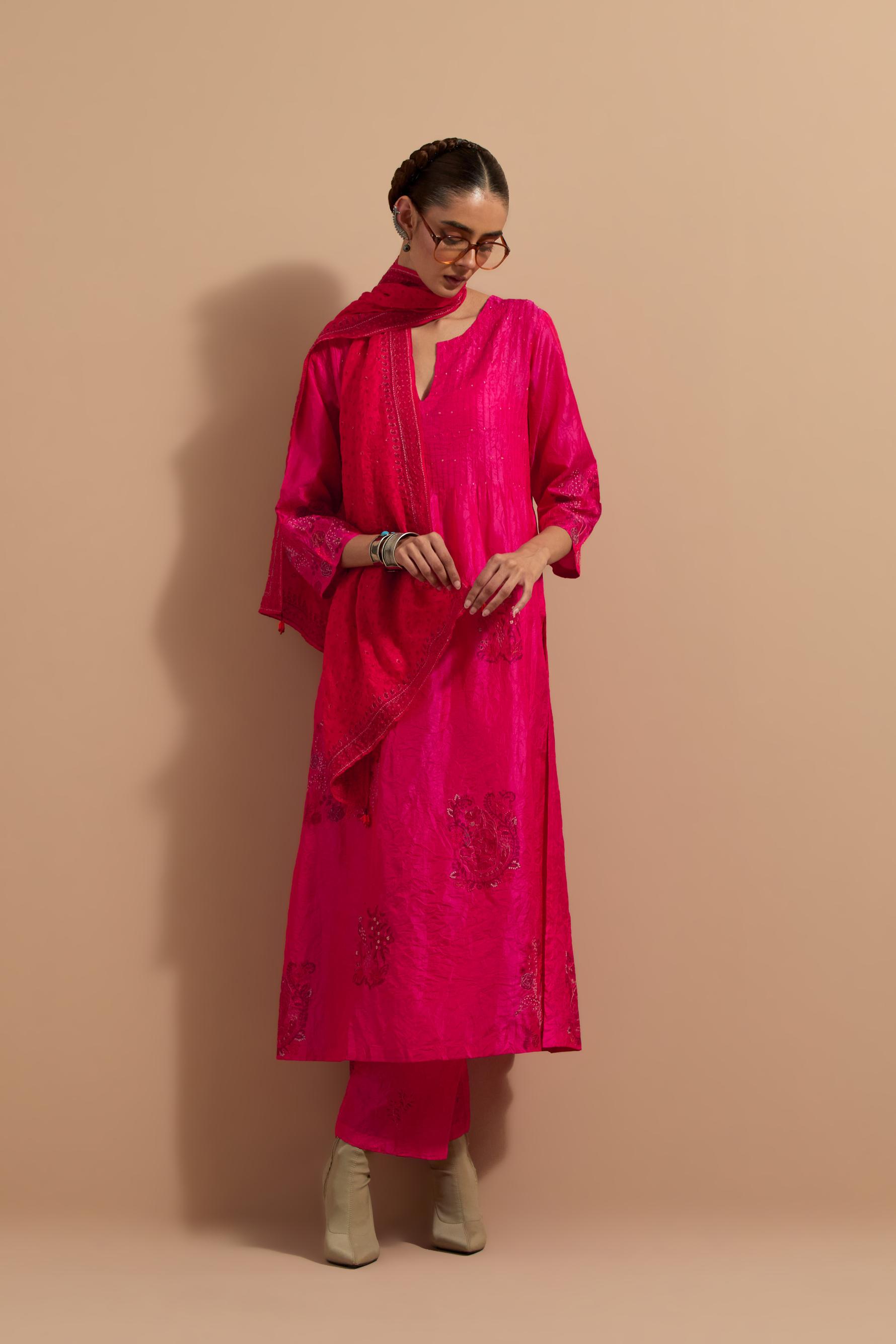 Fuchsia crushed silk hand block printed kurta set with pin tucks at yoke, highlighted with multi colored thread embroidery.