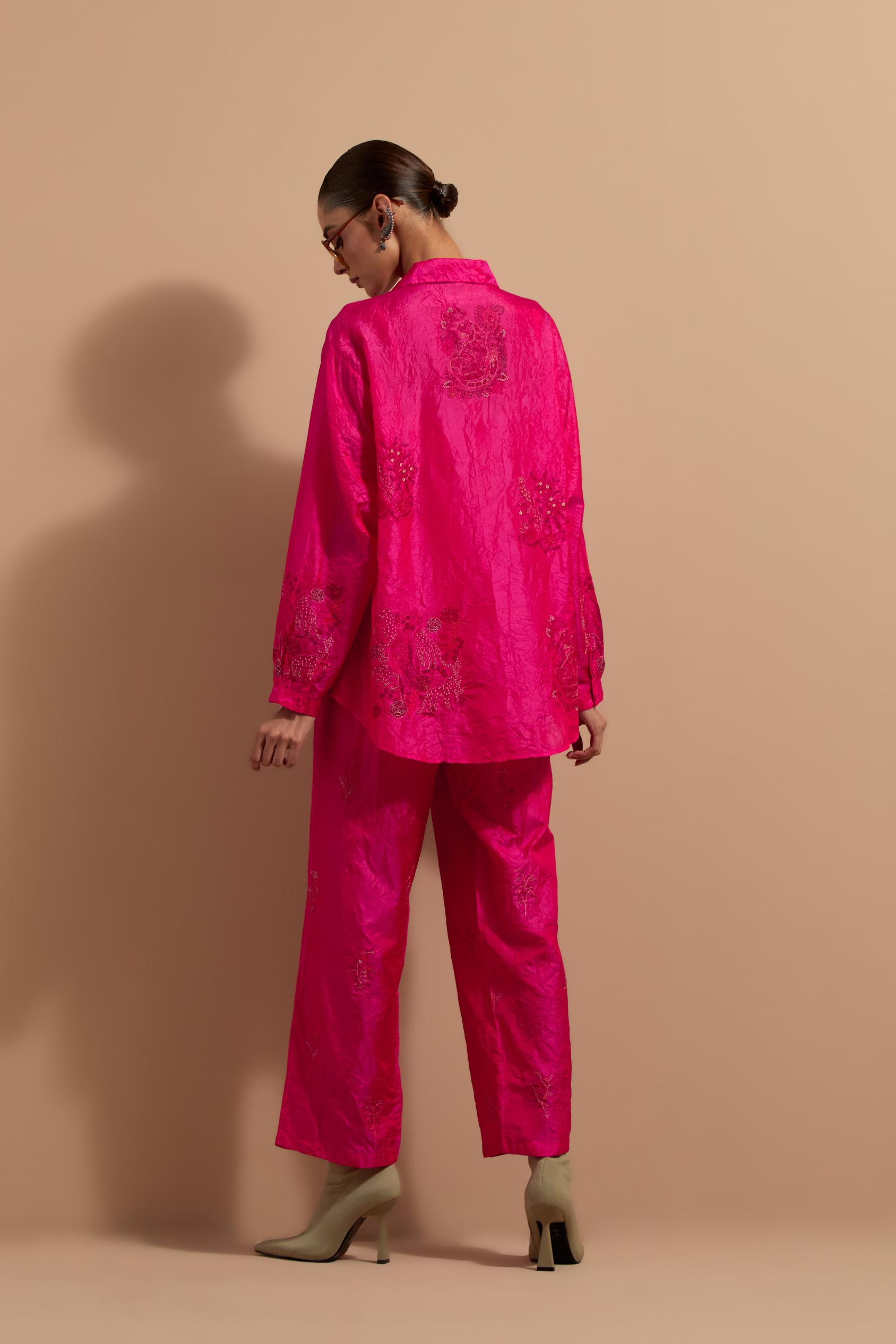 Fuchsia crushed silk hand block printed shirt, highlighted with multi colored thread embroidery, paired with Fuchsia crushed silk hand block printed pants, highlighted with multi colored thread embroidery.