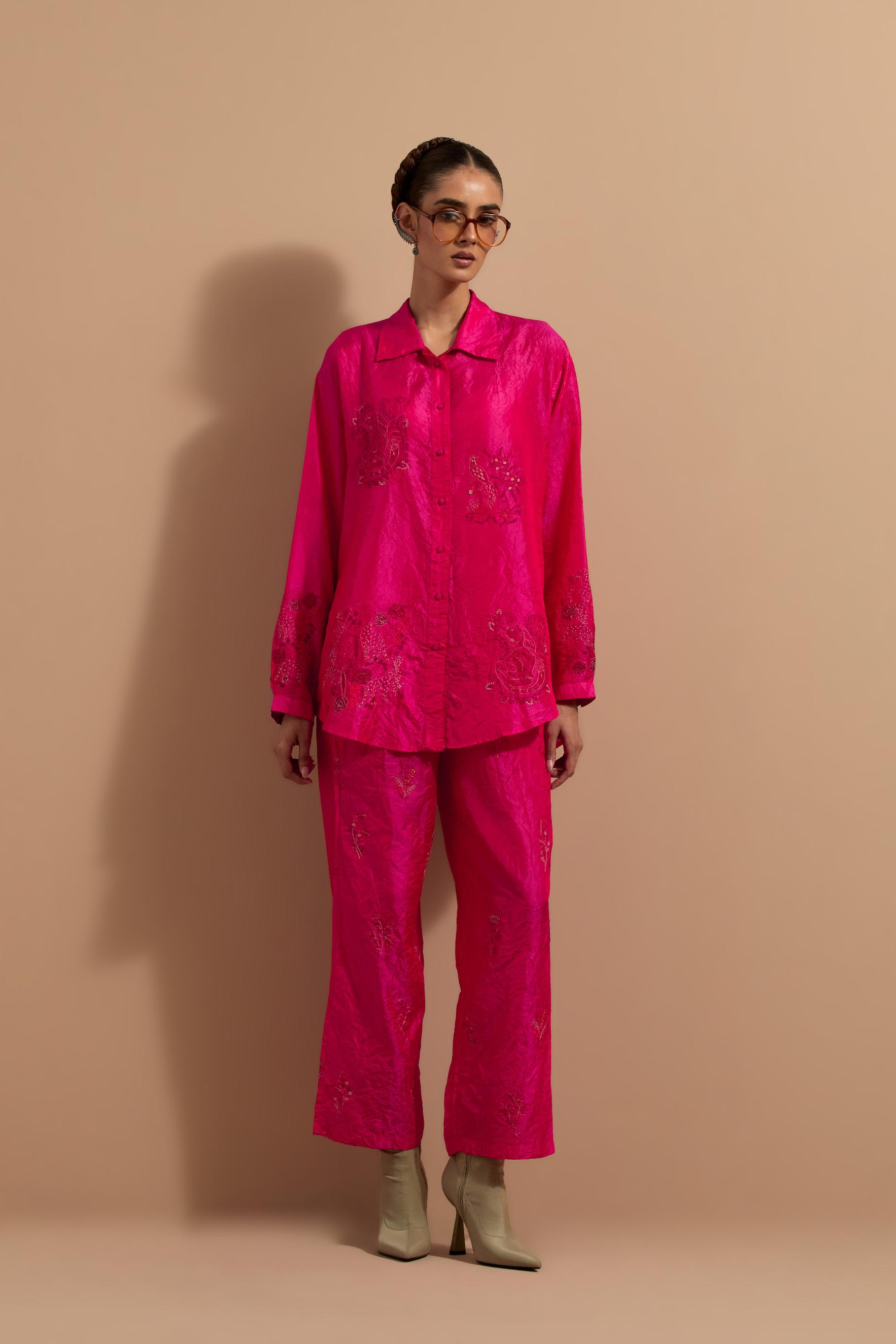 Fuchsia crushed silk hand block printed shirt, highlighted with multi colored thread embroidery, paired with Fuchsia crushed silk hand block printed pants, highlighted with multi colored thread embroidery.