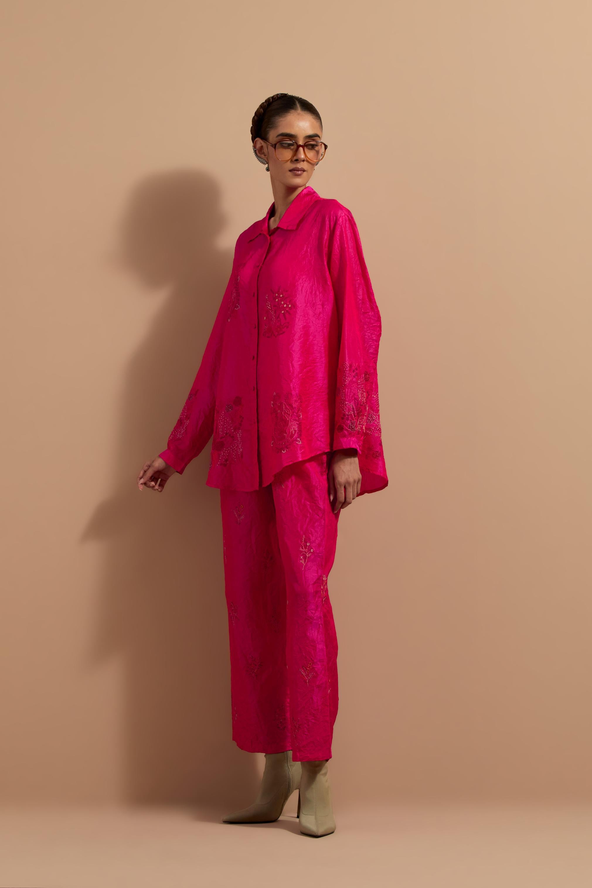 Fuchsia crushed silk hand block printed shirt, highlighted with multi colored thread embroidery, paired with Fuchsia crushed silk hand block printed pants, highlighted with multi colored thread embroidery.