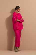 Fuchsia crushed silk hand block printed shirt, highlighted with multi colored thread embroidery, paired with Fuchsia crushed silk hand block printed pants, highlighted with multi colored thread embroidery.