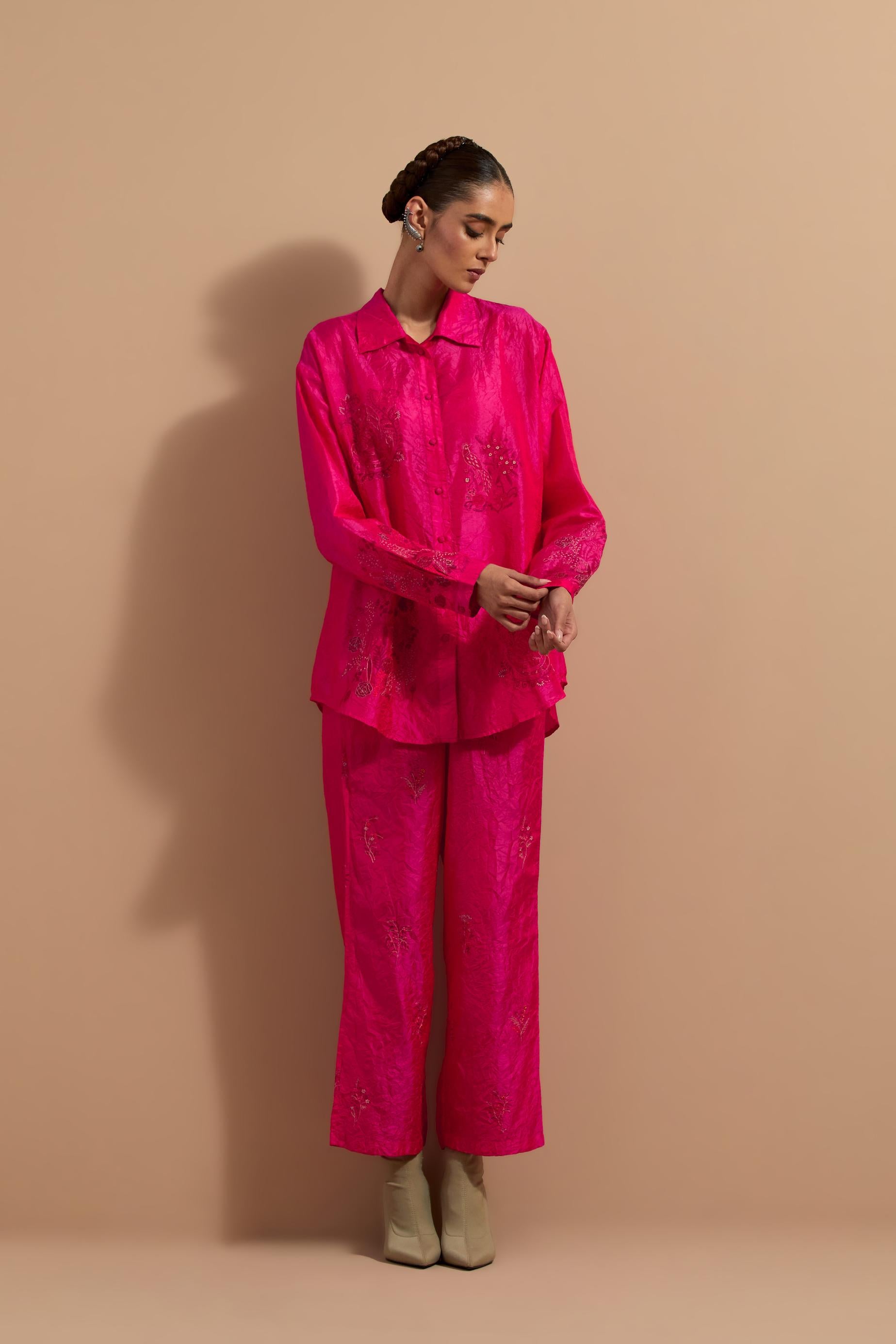 Fuchsia crushed silk hand block printed shirt, highlighted with multi colored thread embroidery, paired with Fuchsia crushed silk hand block printed pants, highlighted with multi colored thread embroidery.