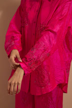 Fuchsia crushed silk hand block printed shirt, highlighted with multi colored thread embroidery, paired with Fuchsia crushed silk hand block printed pants, highlighted with multi colored thread embroidery.