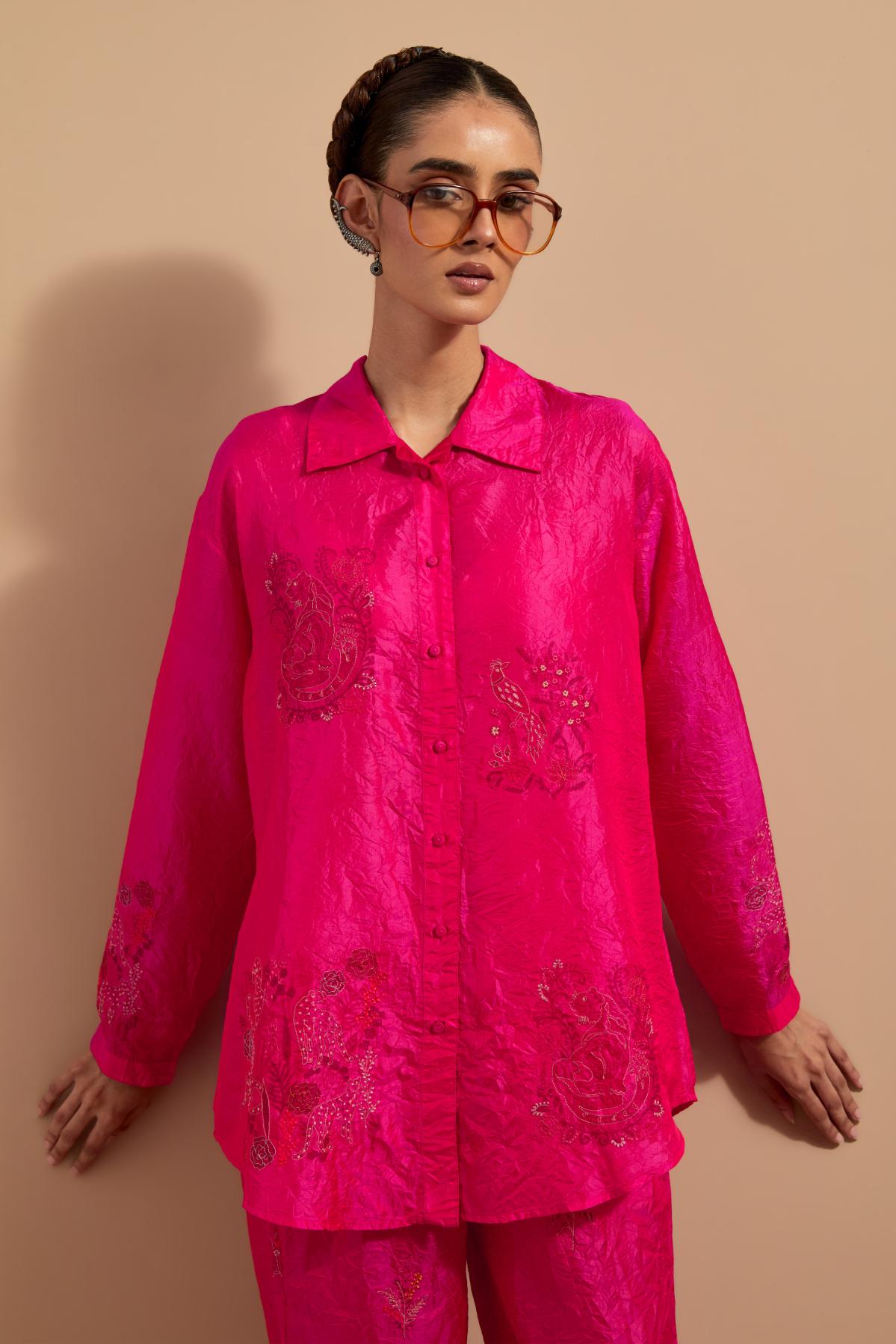 Fuchsia crushed silk hand block printed shirt, highlighted with multi colored thread embroidery, paired with Fuchsia crushed silk hand block printed pants, highlighted with multi colored thread embroidery.