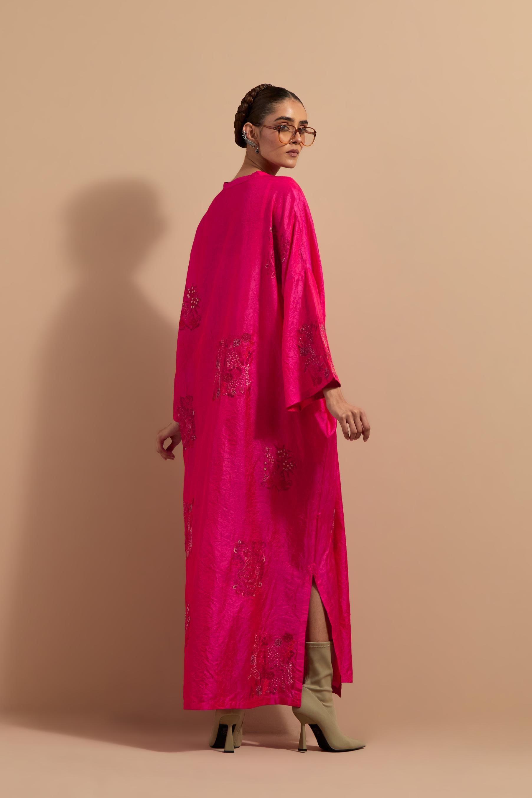 Fuchsia crushed silk hand block printed long kaftan, highlighted with multi colored thread embroidery, paired with Red hand crushed block printed silk stole with quilted embroidery and beaded tassels.