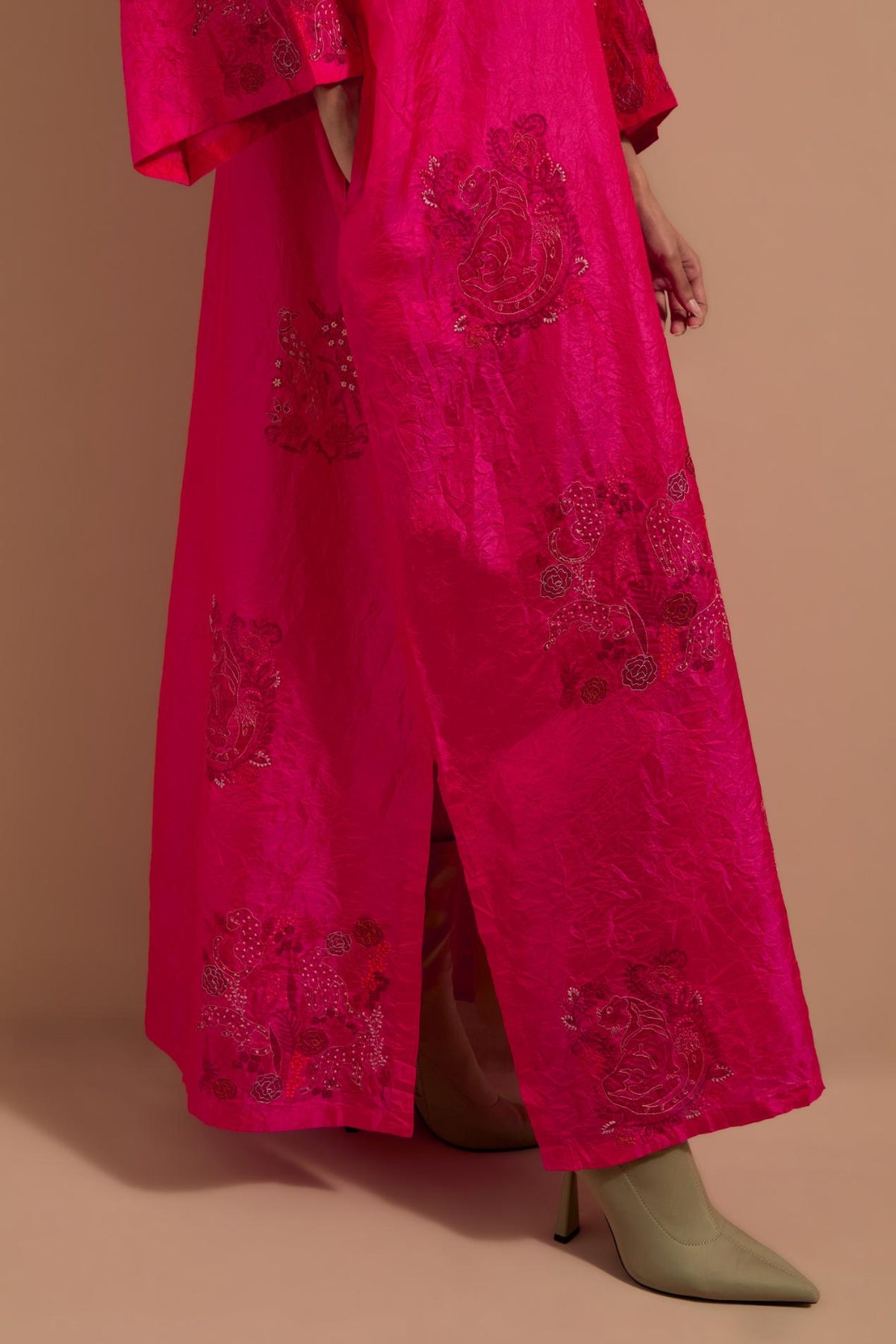 Fuchsia crushed silk hand block printed long kaftan, highlighted with multi colored thread embroidery, paired with Red hand crushed block printed silk stole with quilted embroidery and beaded tassels.