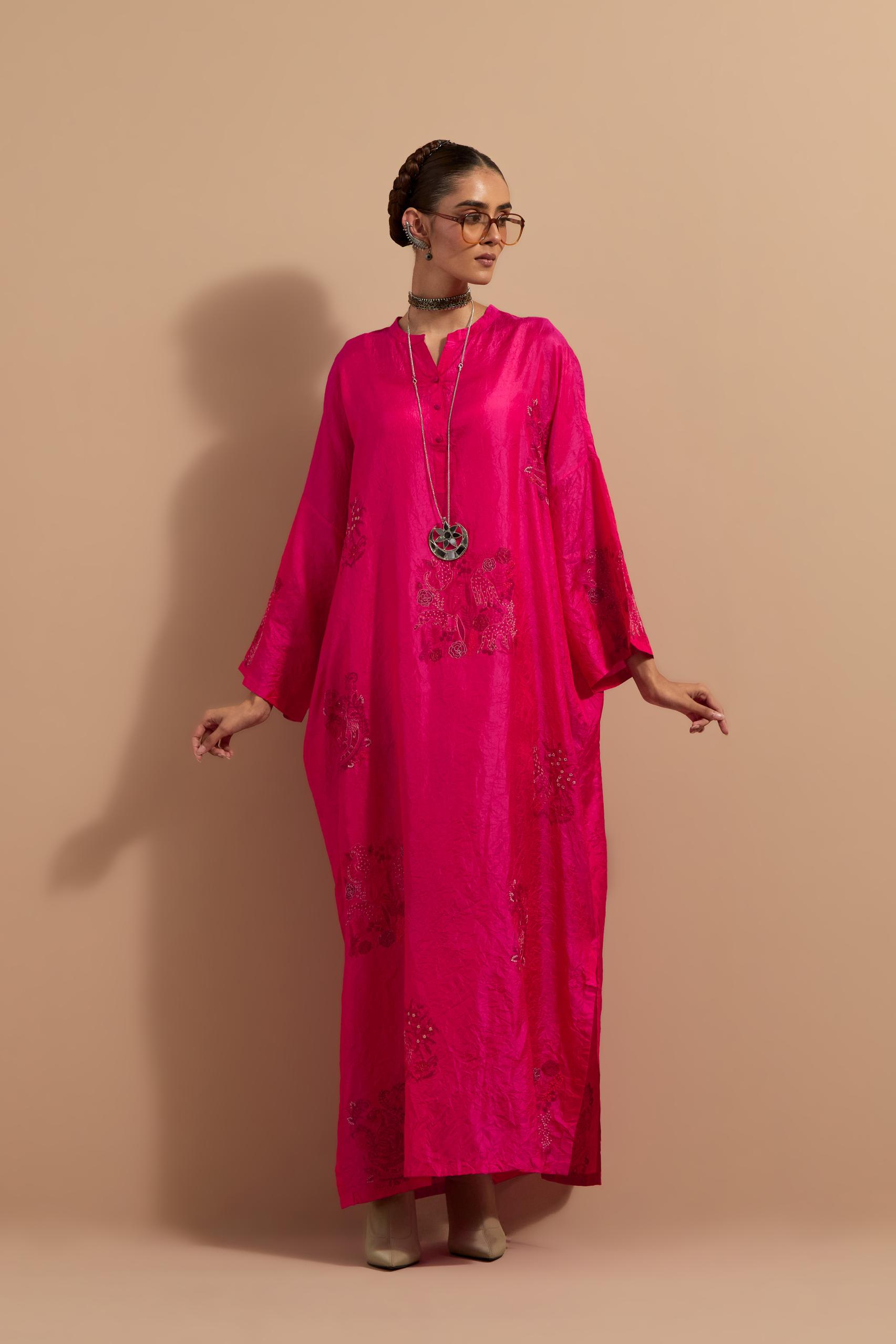 Fuchsia crushed silk hand block printed long kaftan, highlighted with multi colored thread embroidery, paired with Red hand crushed block printed silk stole with quilted embroidery and beaded tassels.
