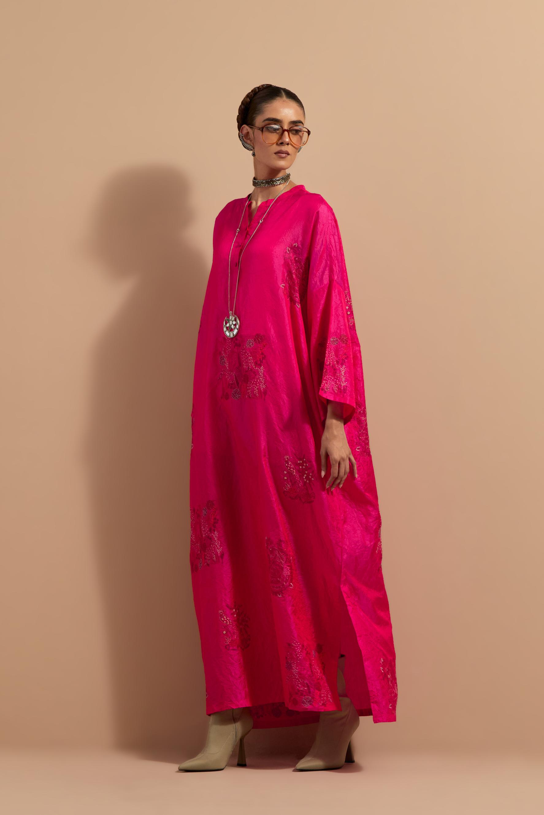 Fuchsia crushed silk hand block printed long kaftan, highlighted with multi colored thread embroidery, paired with Red hand crushed block printed silk stole with quilted embroidery and beaded tassels.