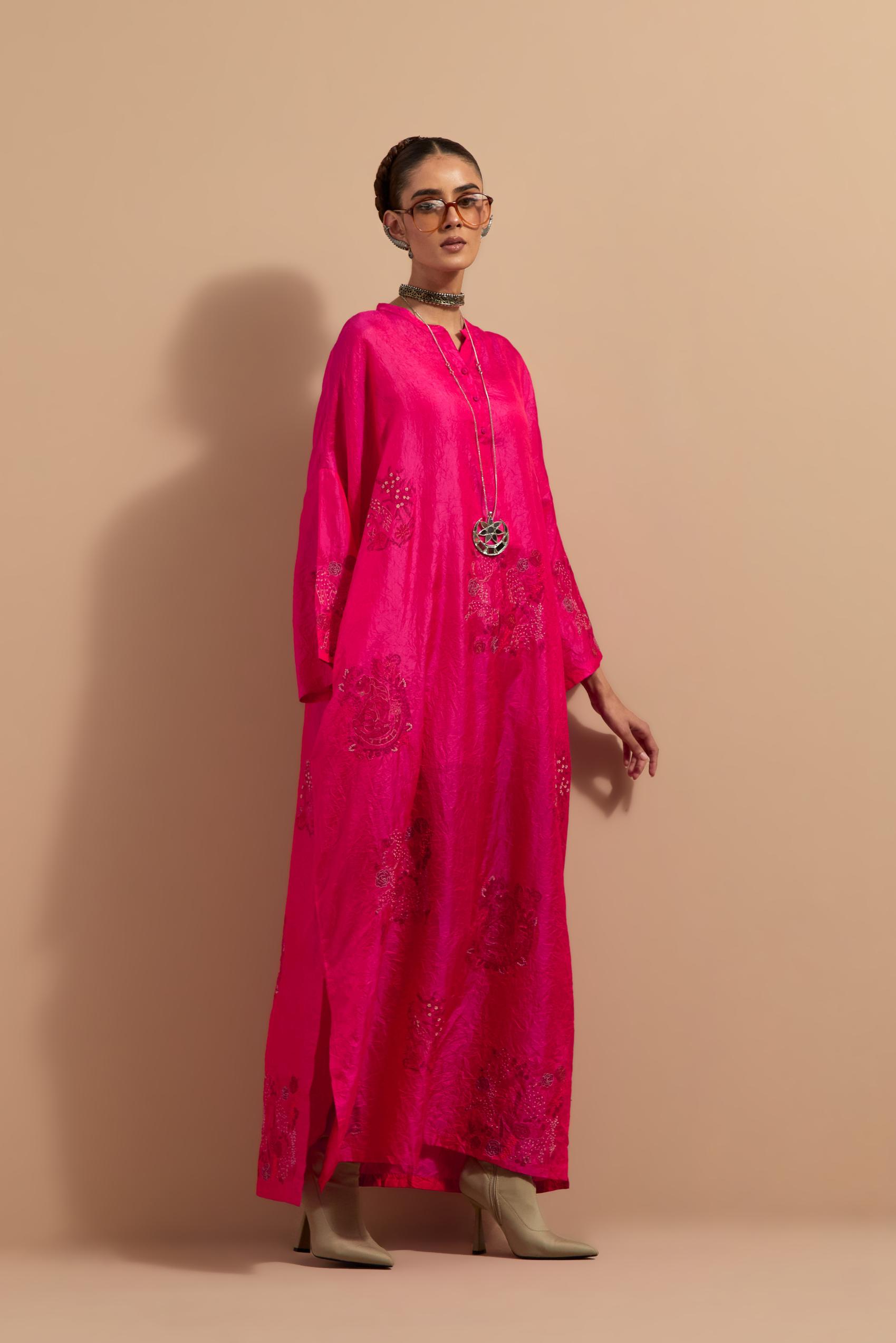 Fuchsia crushed silk hand block printed long kaftan, highlighted with multi colored thread embroidery, paired with Red hand crushed block printed silk stole with quilted embroidery and beaded tassels.