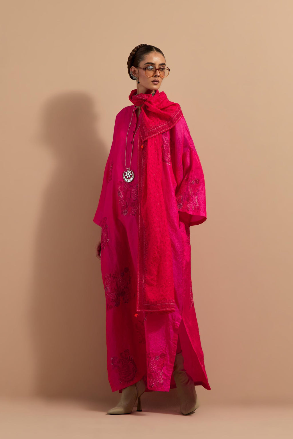 Fuchsia crushed silk hand block printed long kaftan, highlighted with multi colored thread embroidery, paired with Red hand crushed block printed silk stole with quilted embroidery and beaded tassels.