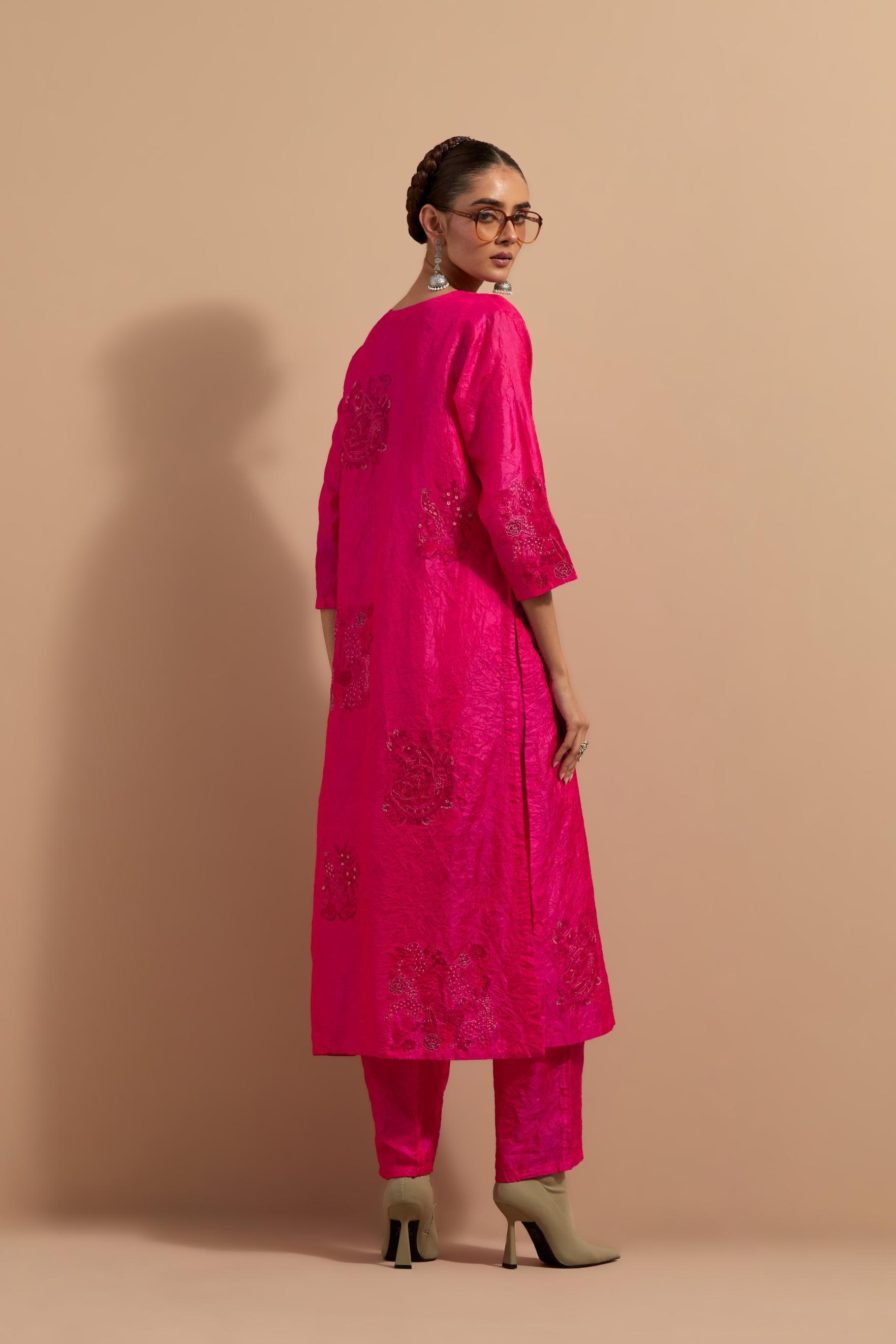 Fuchsia crushed silk hand block printed straight kurta set, highlighted with multi colored thread embroidery.
