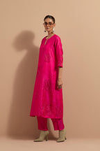 Fuchsia crushed silk hand block printed straight kurta set, highlighted with multi colored thread embroidery.