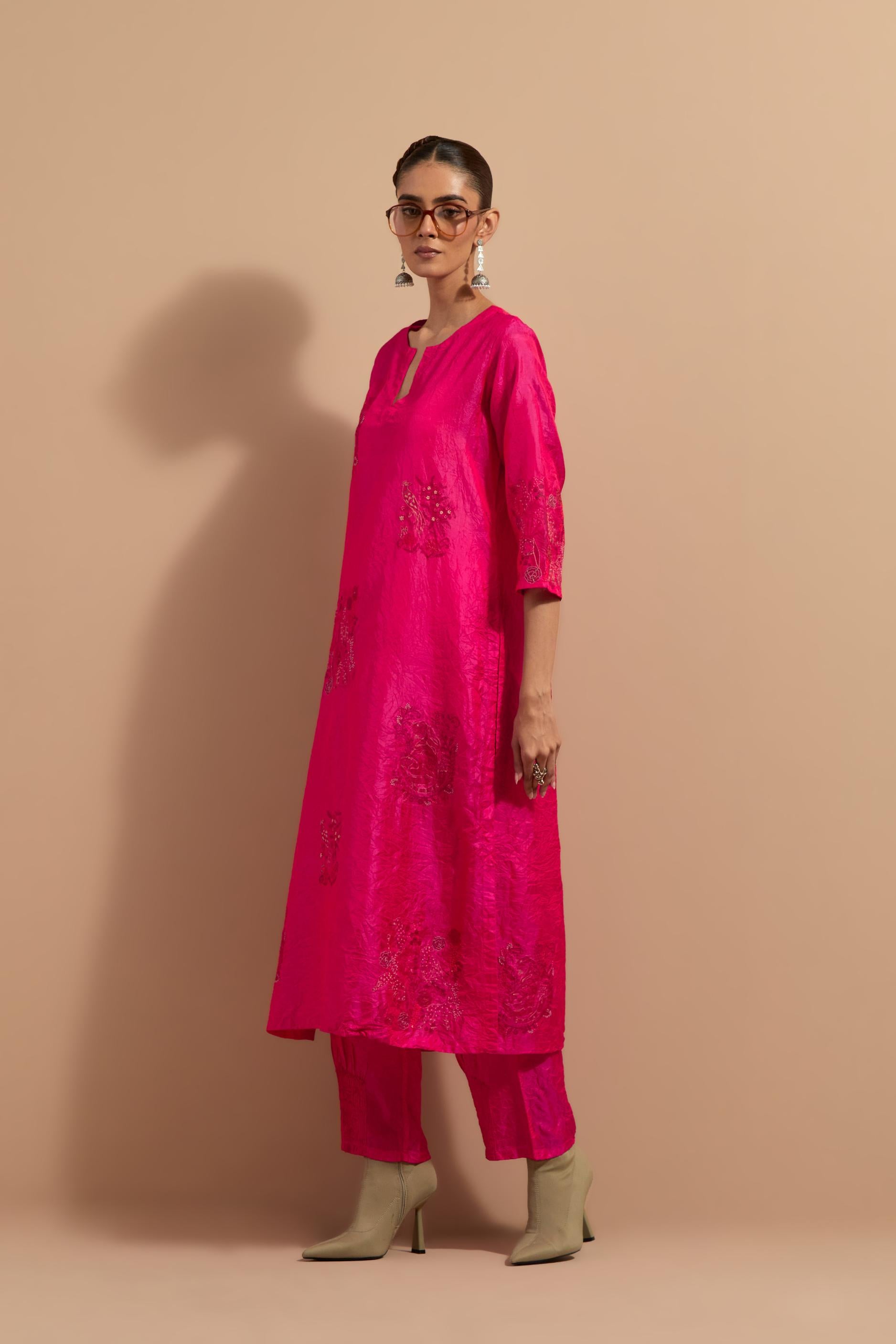 Fuchsia crushed silk hand block printed straight kurta set, highlighted with multi colored thread embroidery.