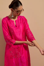Fuchsia crushed silk hand block printed straight kurta set, highlighted with multi colored thread embroidery.