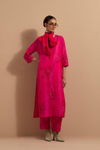 Fuchsia crushed silk hand block printed straight kurta set, highlighted with multi colored thread embroidery.