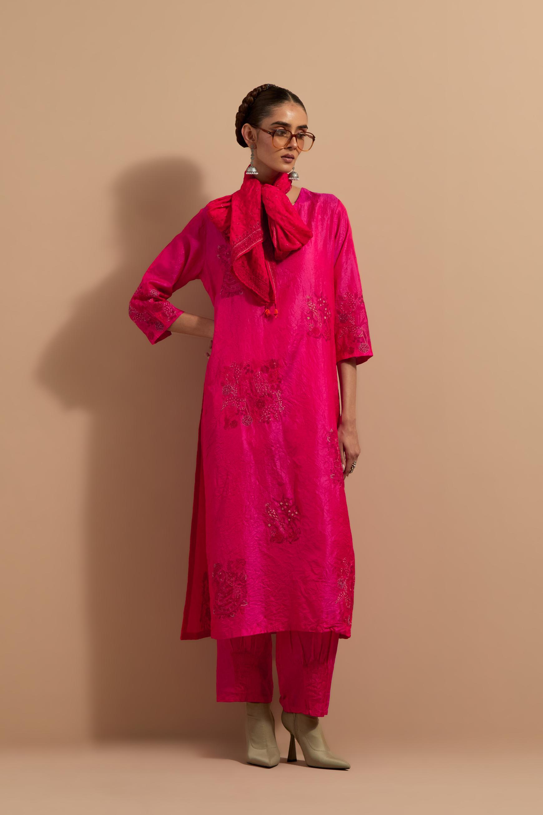 Fuchsia crushed silk hand block printed straight kurta set, highlighted with multi colored thread embroidery.
