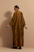 Olive crushed silk hand block printed long kaftan, highlighted with multi colored thread embroidery, paired with Red hand crushed block printed silk stole with quilted embroidery and beaded tassels.