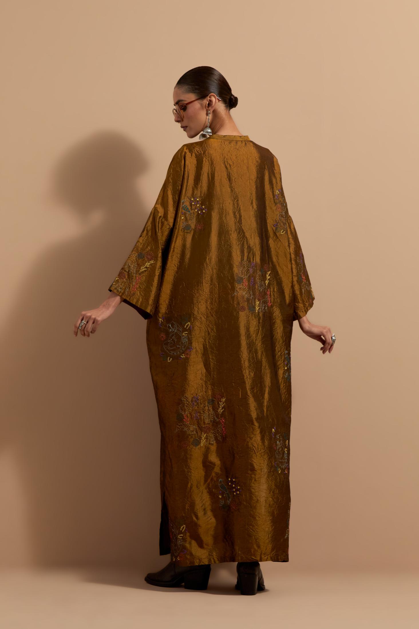 Olive crushed silk hand block printed long kaftan, highlighted with multi colored thread embroidery, paired with Red hand crushed block printed silk stole with quilted embroidery and beaded tassels.