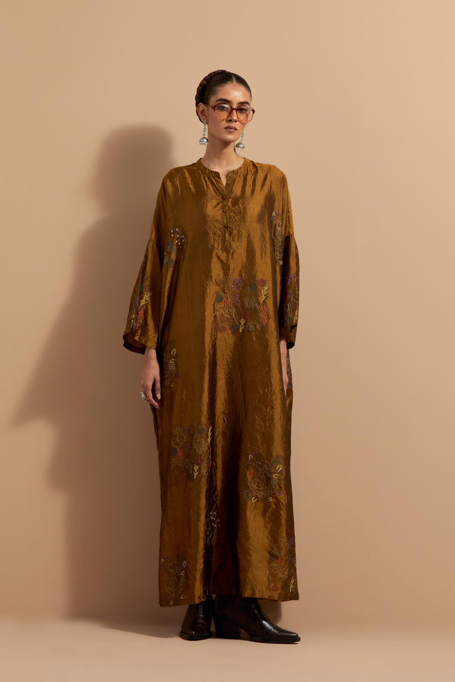Olive crushed silk hand block printed long kaftan, highlighted with multi colored thread embroidery, paired with Red hand crushed block printed silk stole with quilted embroidery and beaded tassels.