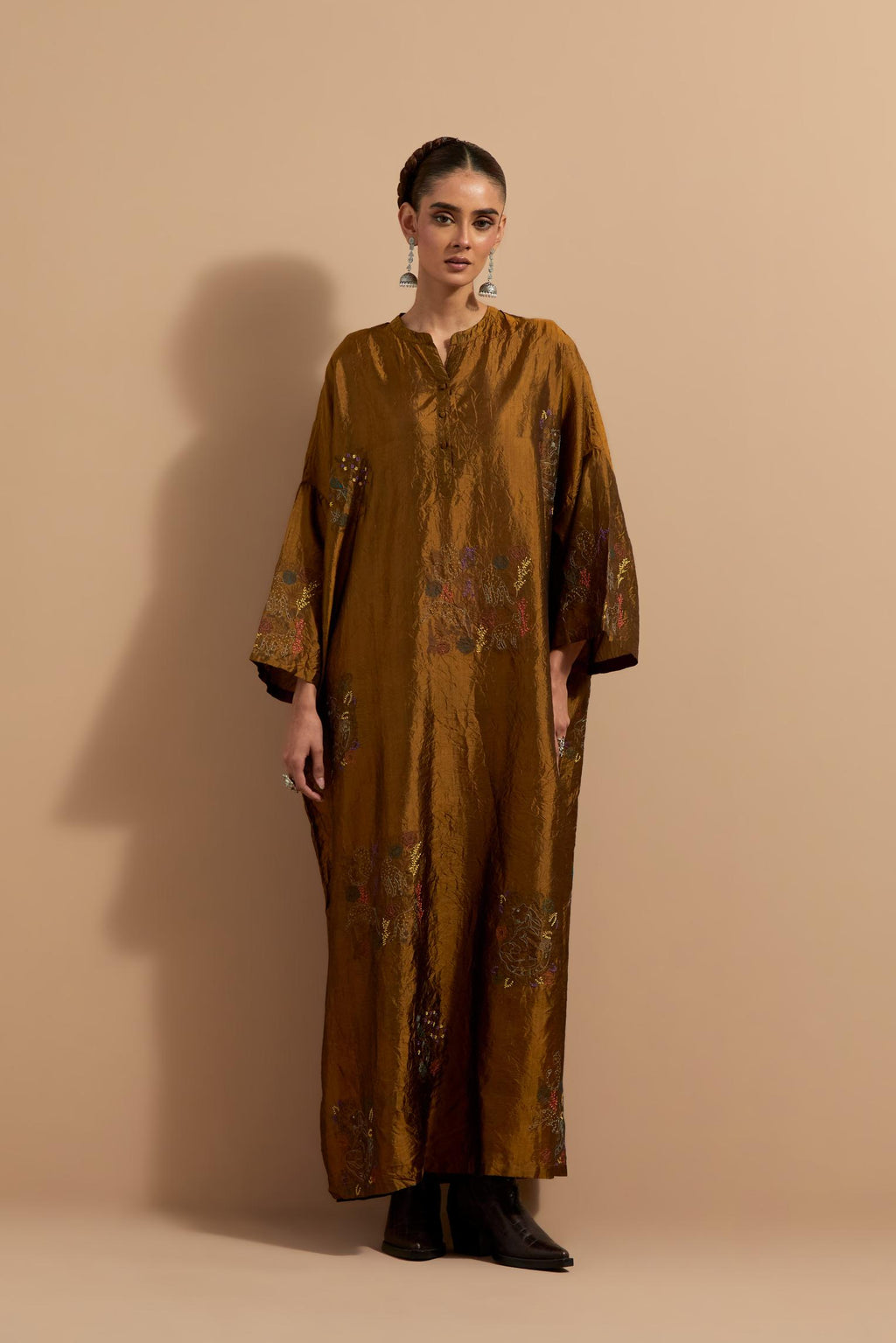 Olive crushed silk hand block printed long kaftan, highlighted with multi colored thread embroidery, paired with Red hand crushed block printed silk stole with quilted embroidery and beaded tassels.