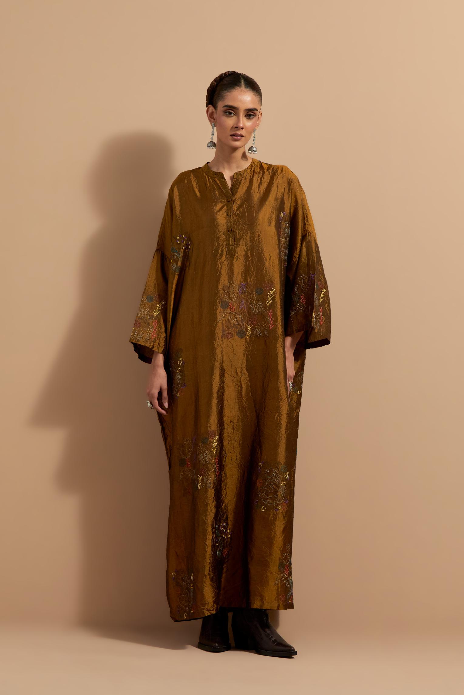 Olive crushed silk hand block printed long kaftan, highlighted with multi colored thread embroidery, paired with Red hand crushed block printed silk stole with quilted embroidery and beaded tassels.