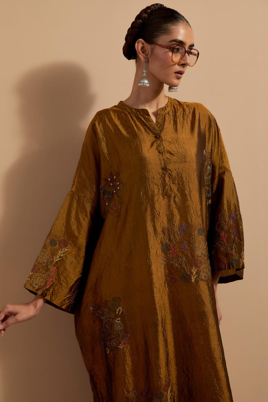 Olive crushed silk hand block printed long kaftan, highlighted with multi colored thread embroidery, paired with Red hand crushed block printed silk stole with quilted embroidery and beaded tassels.