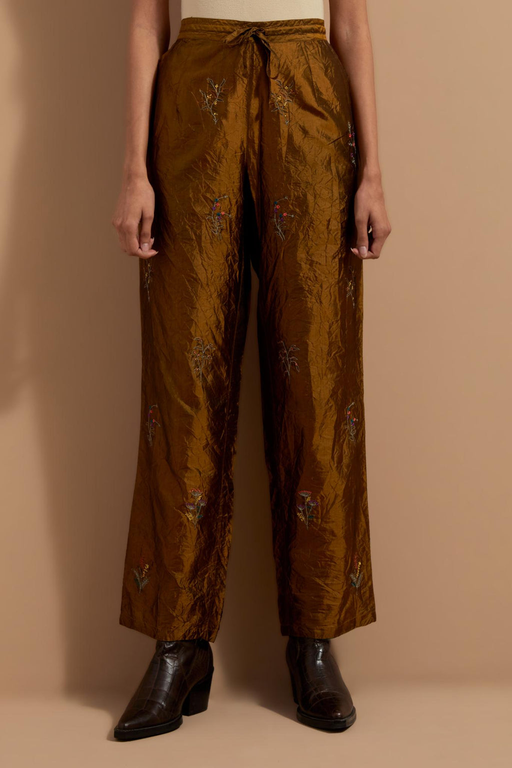 Olive crushed silk hand block printed pants, highlighted with multi colored thread embroidery.