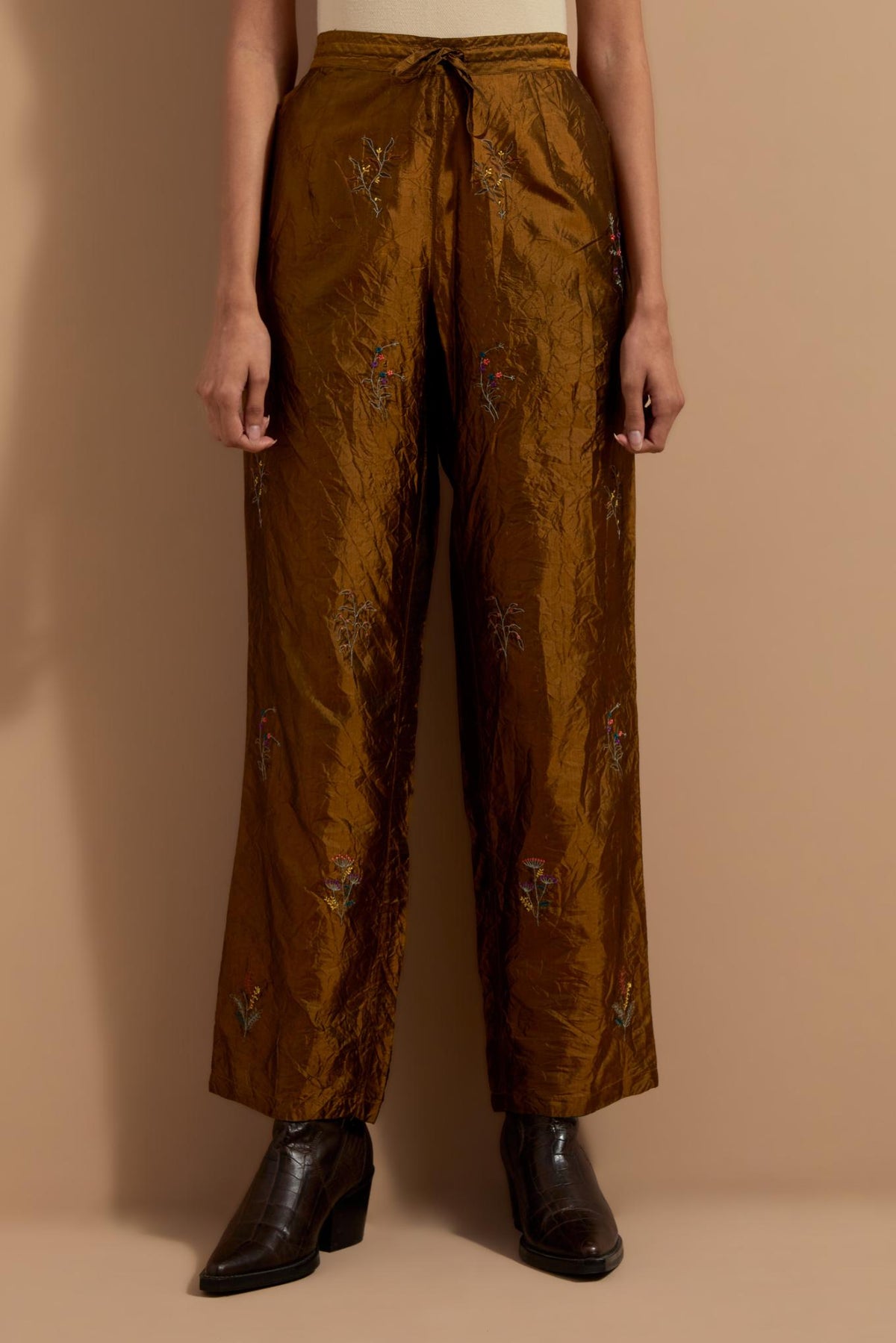 Olive crushed silk hand block printed pants, highlighted with multi colored thread embroidery.