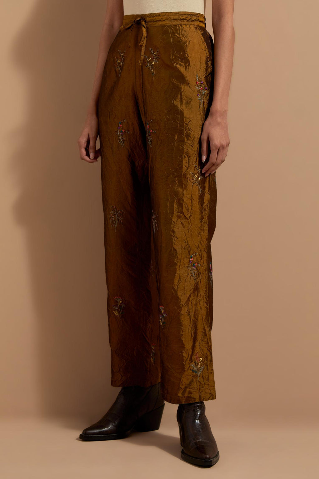 Olive crushed silk hand block printed pants, highlighted with multi colored thread embroidery.
