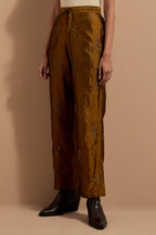 Olive crushed silk hand block printed pants, highlighted with multi colored thread embroidery.