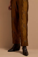 Olive crushed silk hand block printed pants, highlighted with multi colored thread embroidery.