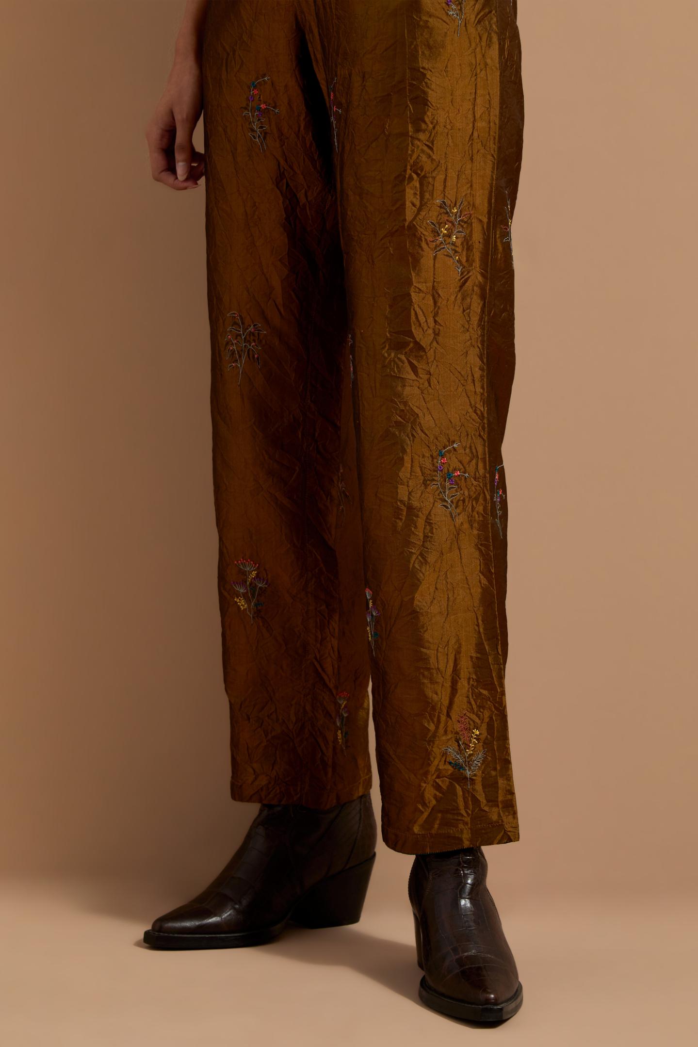 Olive crushed silk hand block printed pants, highlighted with multi colored thread embroidery.
