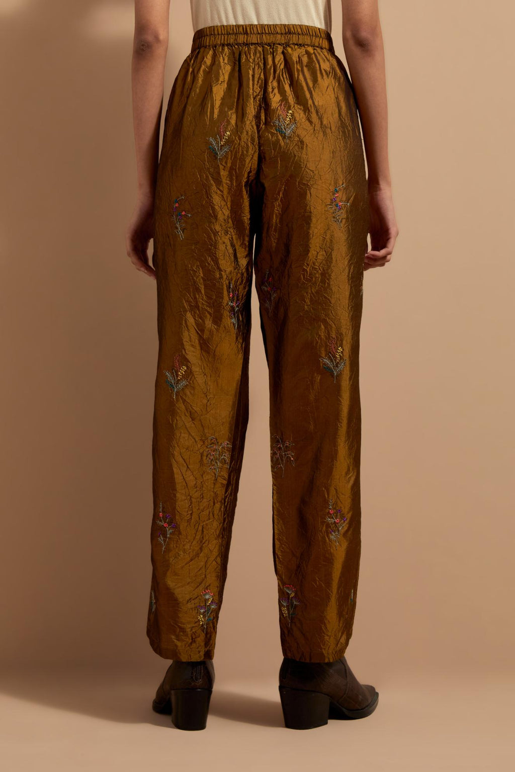 Olive crushed silk hand block printed pants, highlighted with multi colored thread embroidery.