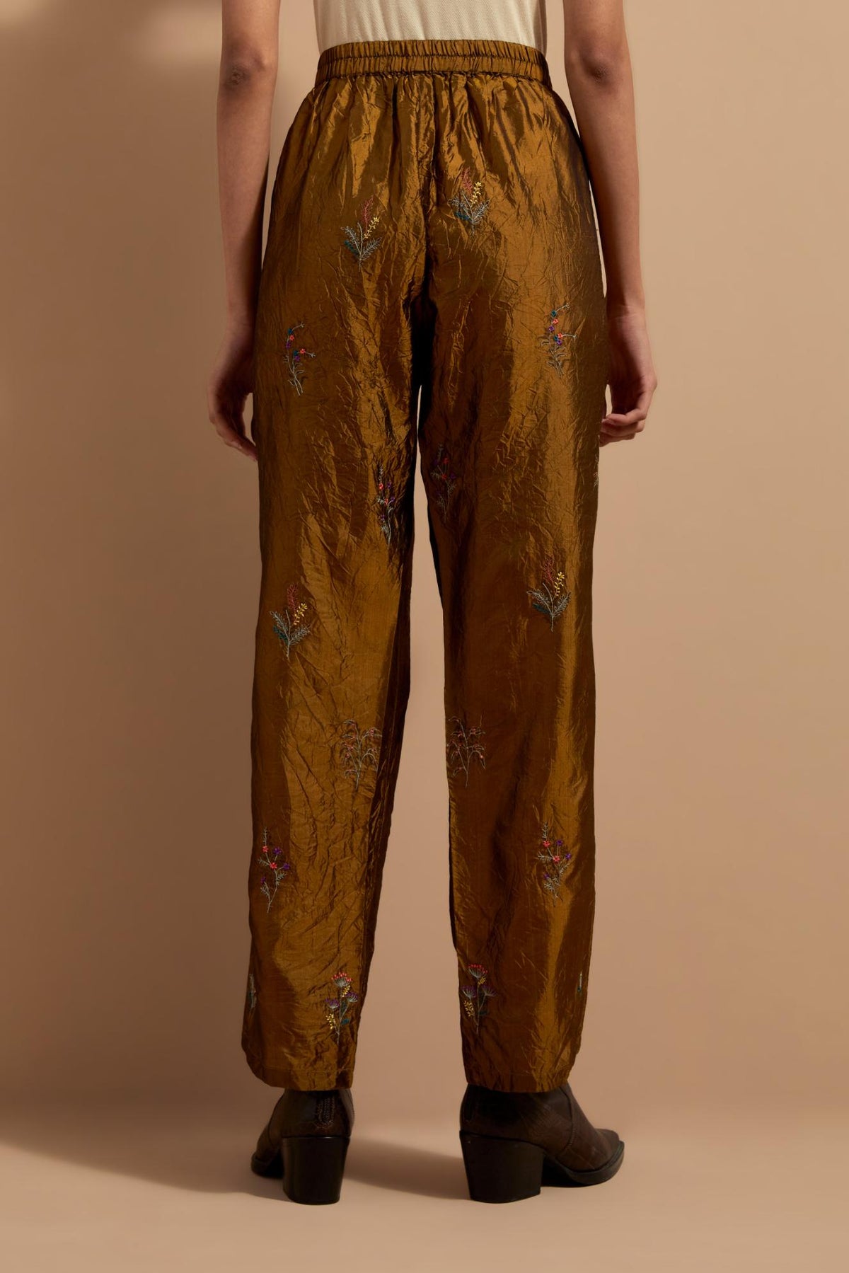 Olive crushed silk hand block printed pants, highlighted with multi colored thread embroidery.