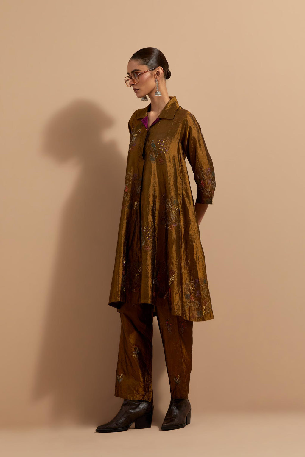 Olive crushed silk A-line short kurta set with hand block print, highlighted with multi colored thread embroidery.