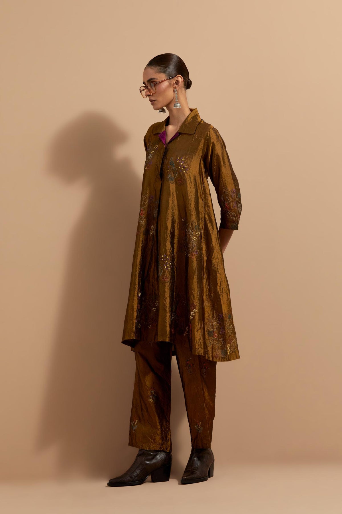 Olive crushed silk A-line short kurta set with hand block print, highlighted with multi colored thread embroidery.