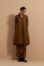 Olive crushed silk A-line short kurta set with hand block print, highlighted with multi colored thread embroidery.