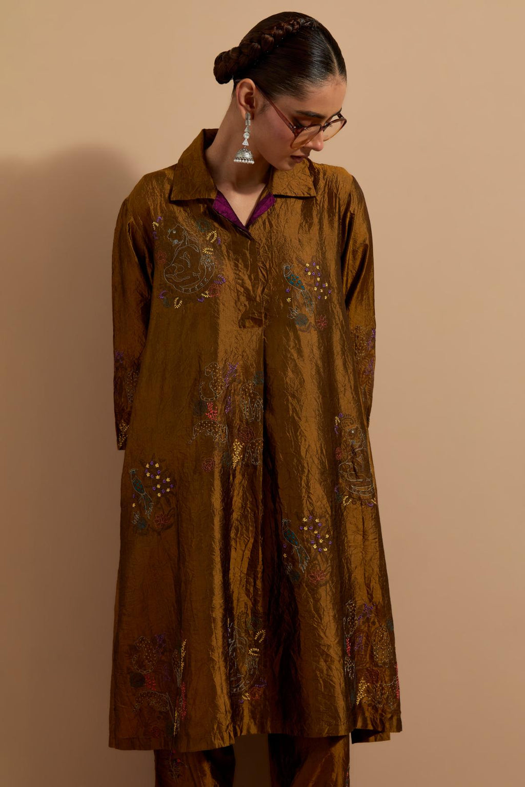 Olive crushed silk A-line short kurta set with hand block print, highlighted with multi colored thread embroidery.