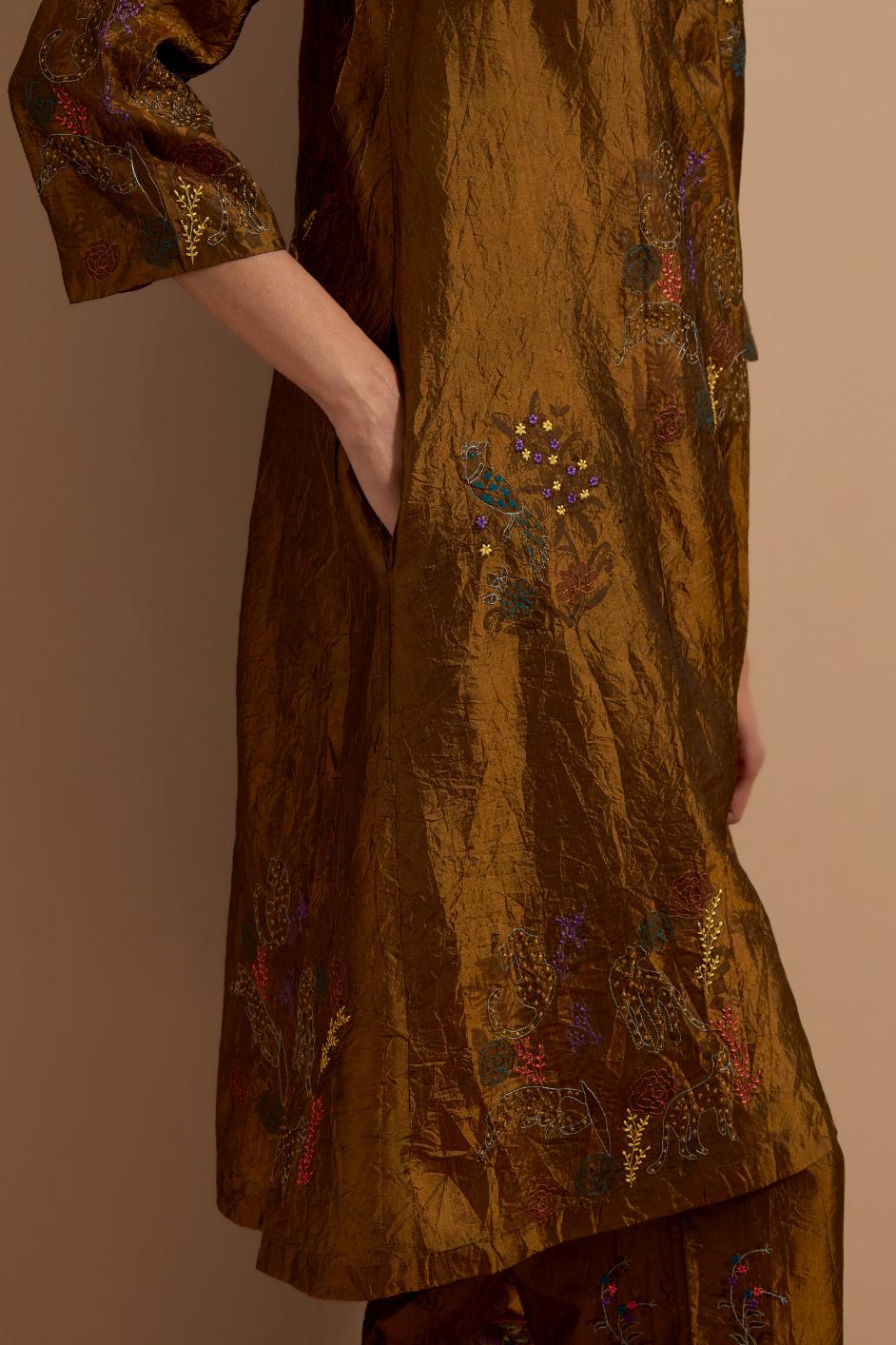 Olive crushed silk A-line short kurta set with hand block print, highlighted with multi colored thread embroidery.