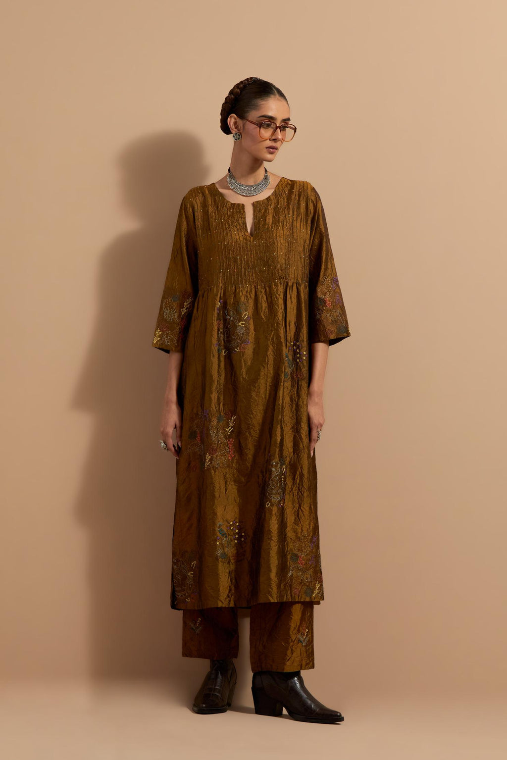 Olive crushed silk hand block printed kurta set with pin tucks at yoke, highlighted with multi colored thread embroidery.