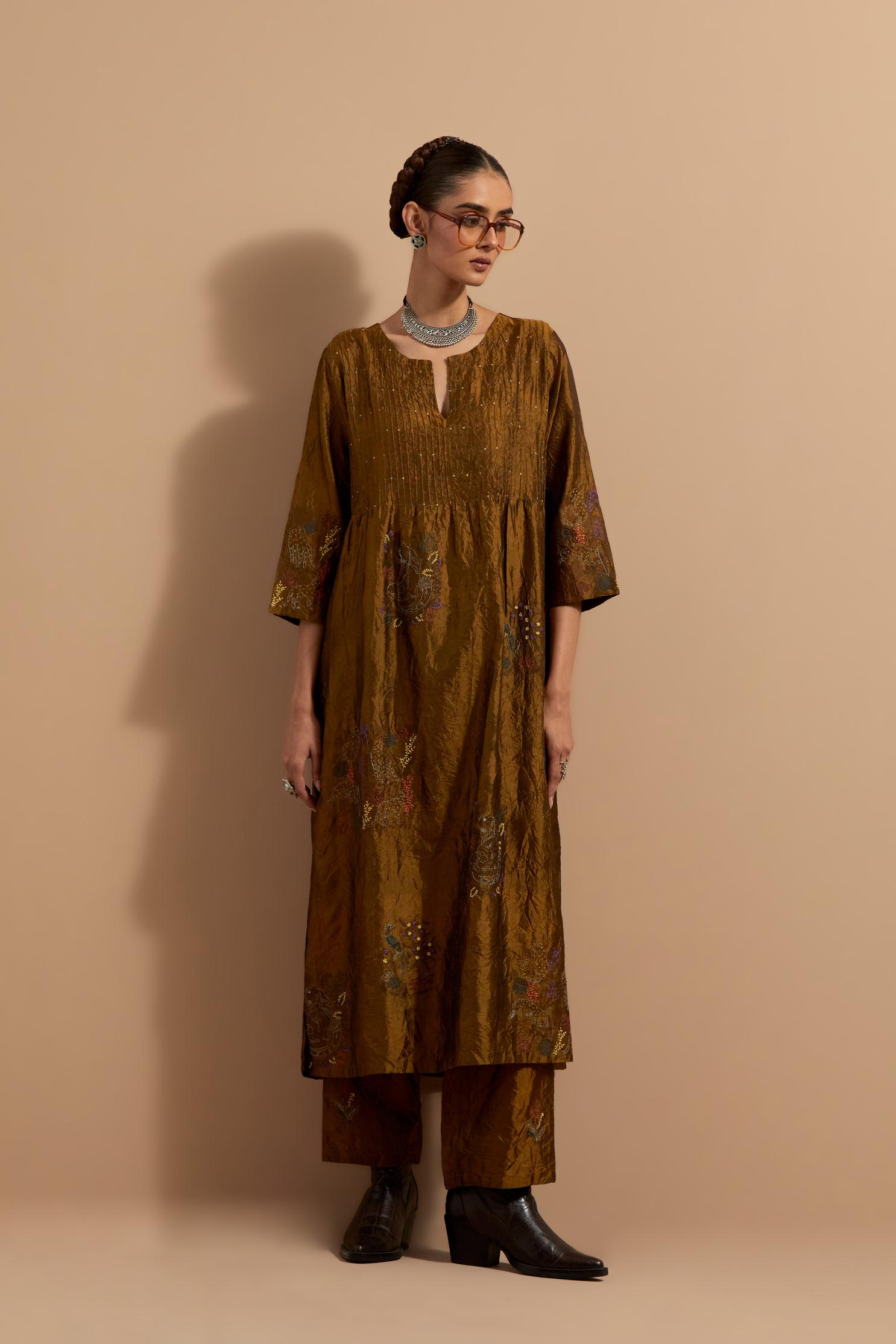 Olive crushed silk hand block printed kurta set with pin tucks at yoke, highlighted with multi colored thread embroidery.