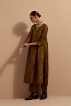 Olive crushed silk hand block printed kurta set with pin tucks at yoke, highlighted with multi colored thread embroidery.