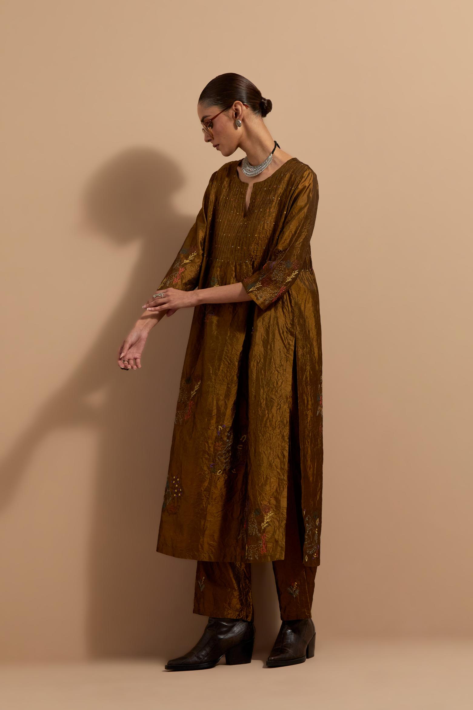 Olive crushed silk hand block printed kurta set with pin tucks at yoke, highlighted with multi colored thread embroidery.