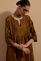 Olive crushed silk hand block printed kurta set with pin tucks at yoke, highlighted with multi colored thread embroidery.